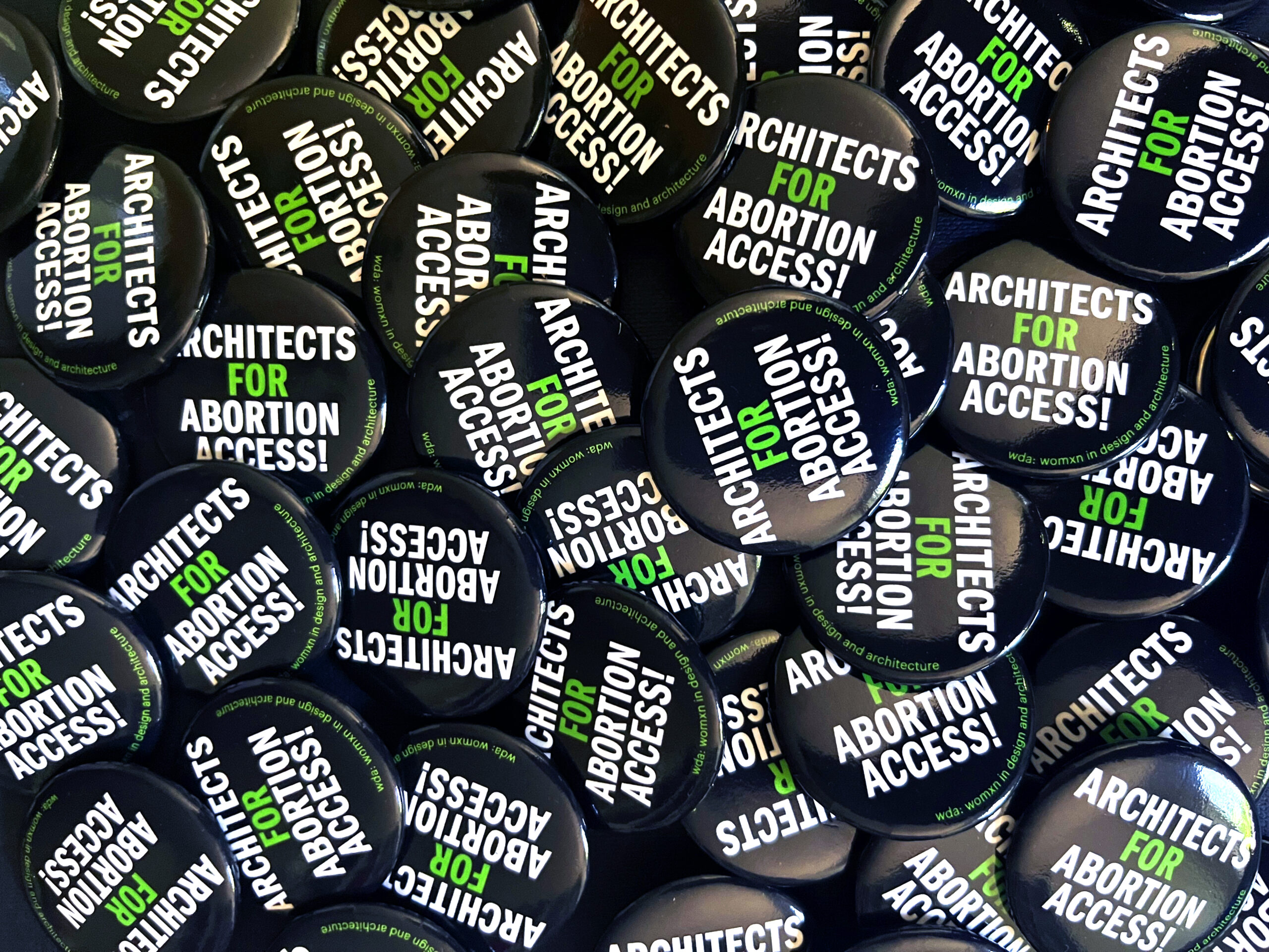 Buttons saying architects for abortion access.